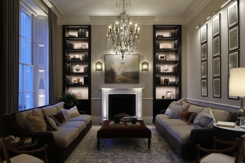 dramatic fireplace with good shelves subtley lit showing the importance of lighting in interior design