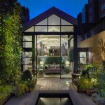 View from garden looking into glass fronted pitched ceiling house