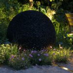 softly lit planting with JOhn CUllen lighting spike lights surrounding a David Harber sculpture
