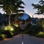 David Harber Torus sculpture with reflections and planting lit by John Cullen Lighting
