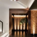 Hallway lit with John Cullen uplights to textured wall